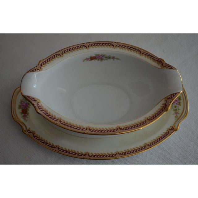 Attached two piece gravy boat and plate. Occupied Japan Noritake. Cream, trimmed in gold with clusters of multi color...