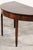 An elegant and timeless antique demilune table from England, showcasing classic Georgian proportions and understated...