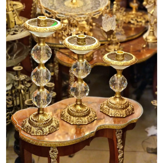 This elegant set of three French style candlestick holders features sparkling faceted crystal elements paired with richly...