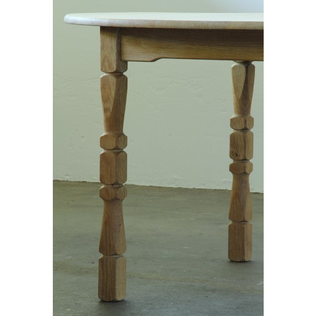 A solid oak dining table with a warm, understated Scandinavian character and beautifully shaped legs. The light oak gives...