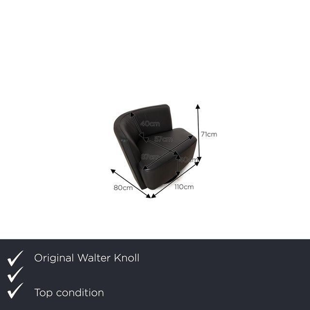 The Drift armchair by Walter Knoll is covered in black genuine leather and stands on a round metal base. It is...