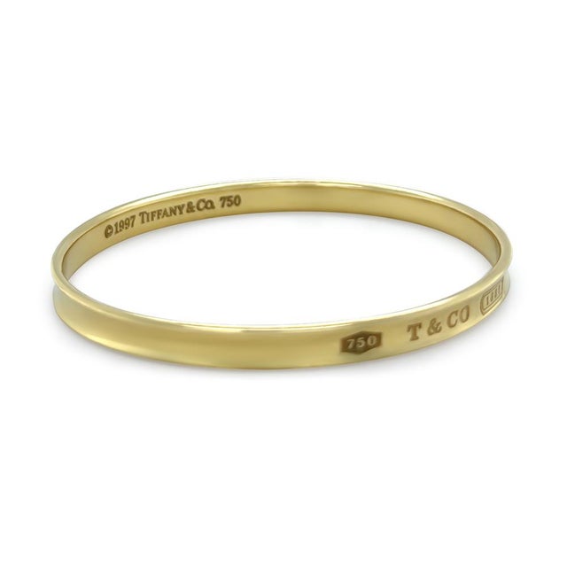A rare Tiffany & Co. 1837 bangle crafted in 18ct yellow gold, dating to circa 1997. Featuring the iconic Tiffany 1837...