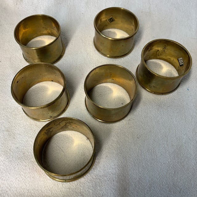 These are vintage solid brass napkin rings featuring a classic mid-century modern minimalist design with a warm golden...