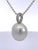 A large, luminous baroque pearl anchors this classic pendant, its soft ivory-white surface glowing with subtle rosé and...