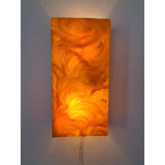 Yellow wall light by Uwe Mersch made of structured plastic and aluminum. This piece has an attribution mark, I am sure...