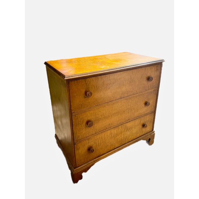 An early 20th century reproduction of a classic Federal style commode. Made of tiger maple with wood pulls, dovetailed...