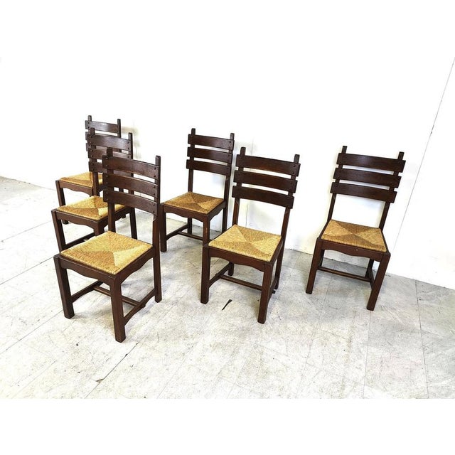 Vintage sturdy oak and wicker brutalist style dining chairs. Sturdy ever lasting oak frames with thick wicker seats. The...