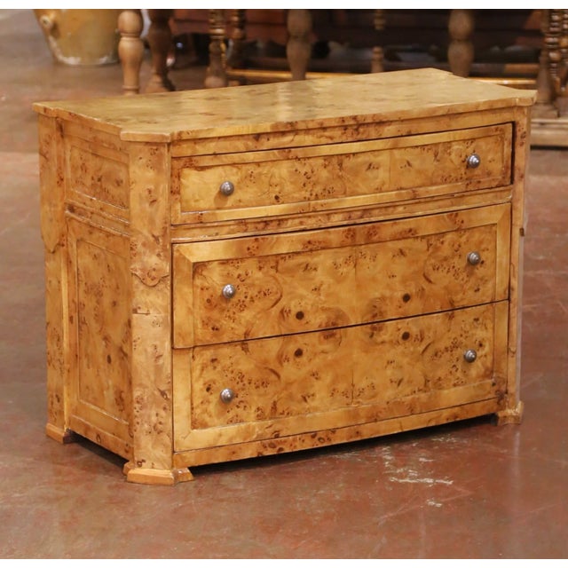 Crafted in France circa 1950, this elegant Charles X style chest showcases the dramatic beauty of richly figured burl elm....