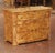 Crafted in France circa 1950, this elegant Charles X style chest showcases the dramatic beauty of richly figured burl elm....