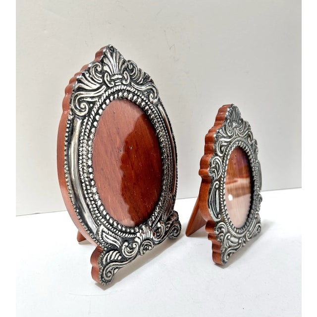 A striking pair of 1940s sterling silver repoussé oval picture frames, handcrafted in Peru. The frames feature intricate...