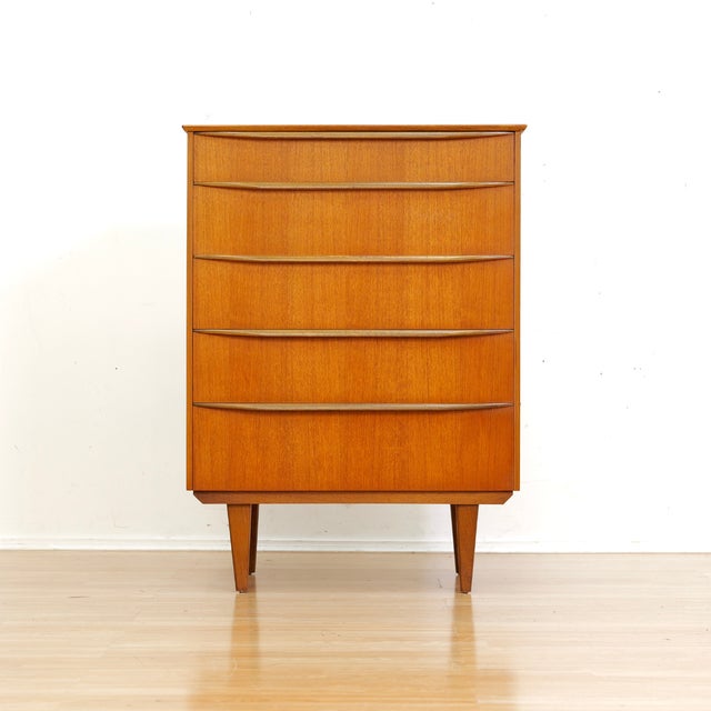 This handsome vintage dresser was designed and manufactured in England during the 1960s. A tall striking piece with plenty...