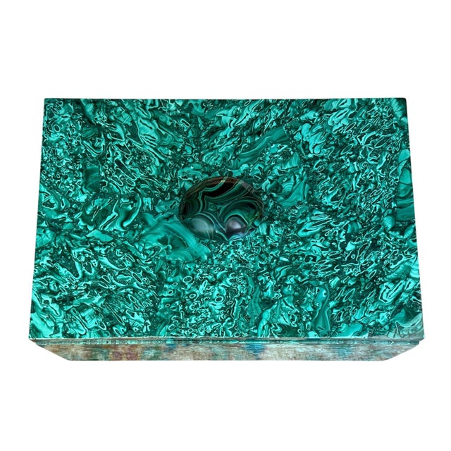 A striking malachite lidded box of substantial scale, distinguished by the exceptionally vivid natural figuring and...