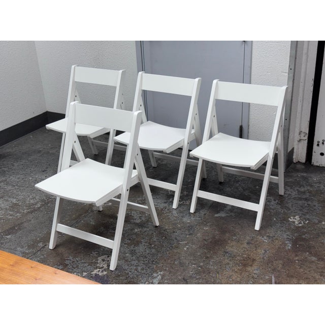Design Plus Gallery presents a Set of Four Spare Folding Chairs from Crate & Barrel. The set of clean-lined white folding...