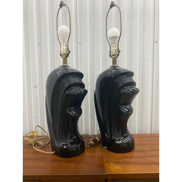 1980s ceramic "wave" lamps, designed in an Art Deco revival or postmodern style.The bases feature a high-gloss black...