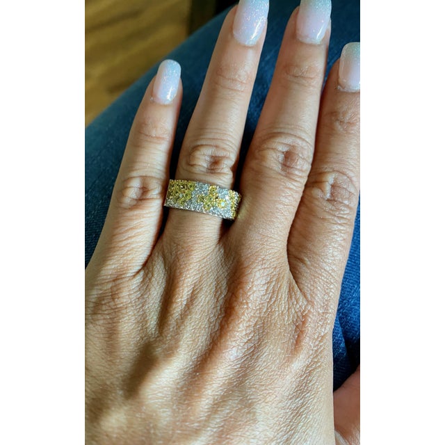 This unique band has a cluster of 35 Yellow Sapphires that weighs 1.27 Carats and 75 Round Cut Diamonds that weigh 0.91...