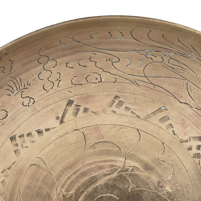 This is a stunning mid-century brass serving bowl with an engraved Chinese dragon design. The bowl features a brass finish...