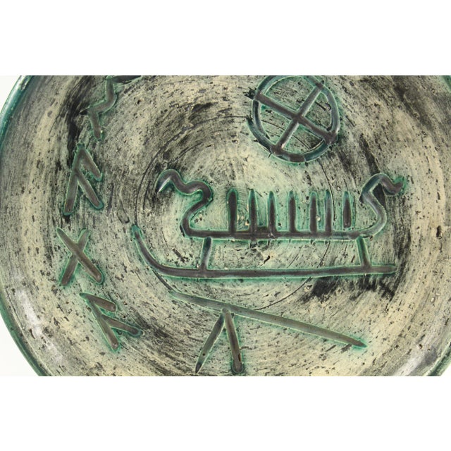 An emblematic studio pottery plate It features stylized Viking ship and other ancient Norse symbols Made in the studio of...