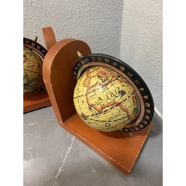 Add a touch of classic charm to your bookshelf with these beautifully crafted vintage wooden globe bookends. Featuring...