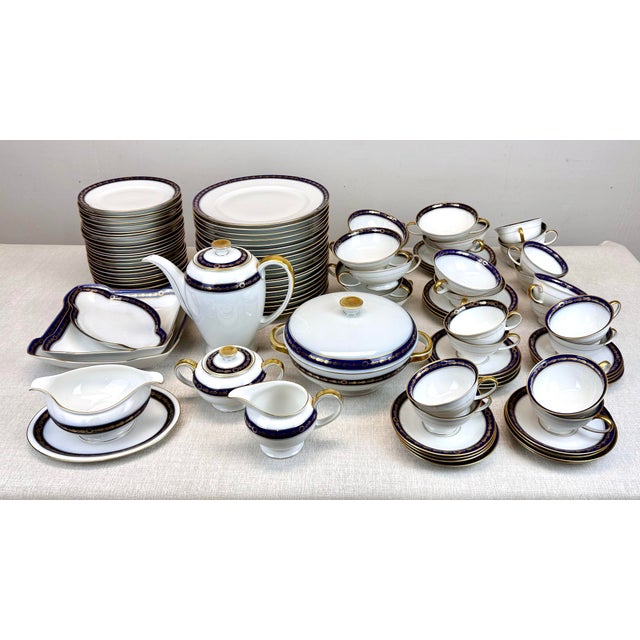 A gorgeous, elegant 1940’s era porcelain dinner set by Rosenthal, Selb, Germany featuring gilt floral design over deep...