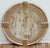 Large round wall mirror features a distinctive circular frame composed of individual carved weathered wood panels joined...