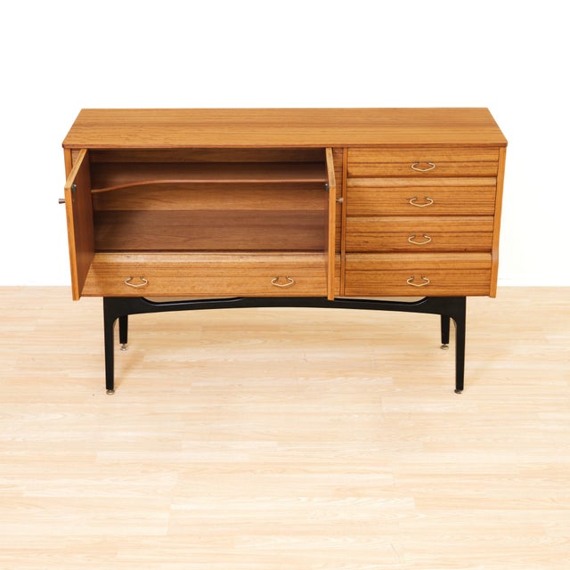 This elegant mid-century teak sideboard by Jentique Furniture beautifully captures the clean lines and refined...