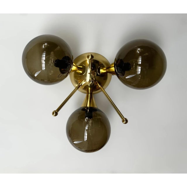 Italian flush mount with three smoky Murano glass globes mounted on solid brass frame in lacquered polished brass finish /...