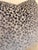 Contemporary accent pillow featuring a sophisticated abstract leopard-inspired pattern in soft gray, charcoal, and taupe...