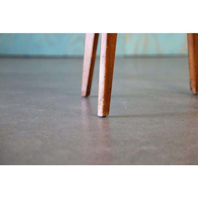 An early splay leg table with birch legs and a laminate wood top. Believed to be an early example from Jens Risom, for...