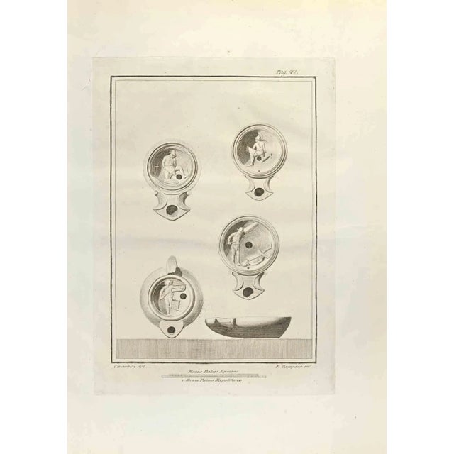 Oil Lamps with Fighting Soldiers from "Antiquities of Herculaneum" is an etching on paper realized by Ferdinando Campana...
