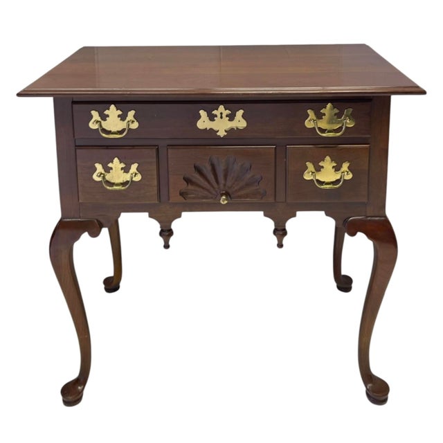 This is a timeless Queen Anne style carved mahogany low boy or chest. It has a scalloped valance with two hanging finials....