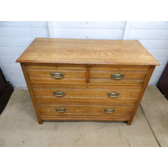 This Edwardian Oak Chest of Drawers is a classic piece of antique furniture with a country style design. Made from solid...