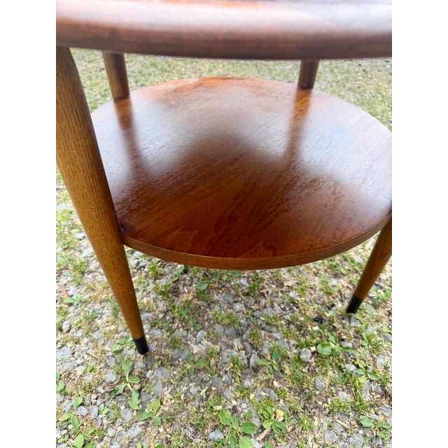 Vintage walnut and oak side table from the Lane Acclaim series. It features a lower circular shelf for additional storage....