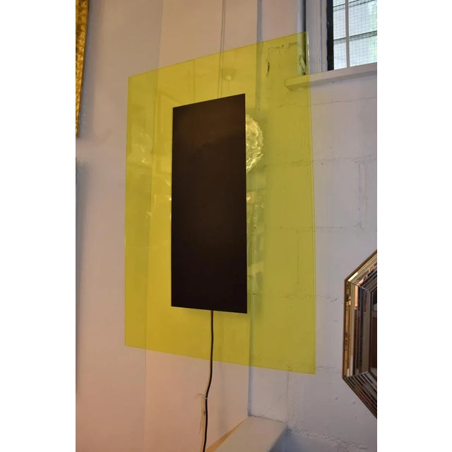 This Art lighting panel in yellow and black acrylic glass, with florescent light bulbs, was designed by Johanna Grawunder,...