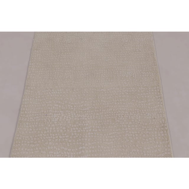 Hand-knotted in a luxurious, intricate blend of wool and silk, this 2x13 contemporary runner rug is an elegant new...