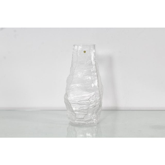 Beautiful and unusual thick and heavy 'glacier' clear glass vase, with an irregular shape, made by Peill & Putzler of...