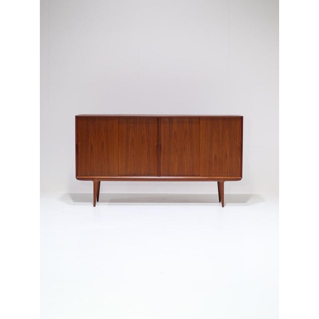 Highboard model 19, designed by Gunni Omann for Omann Jun in Denmark in the 1960s. This tall sideboard is made of...