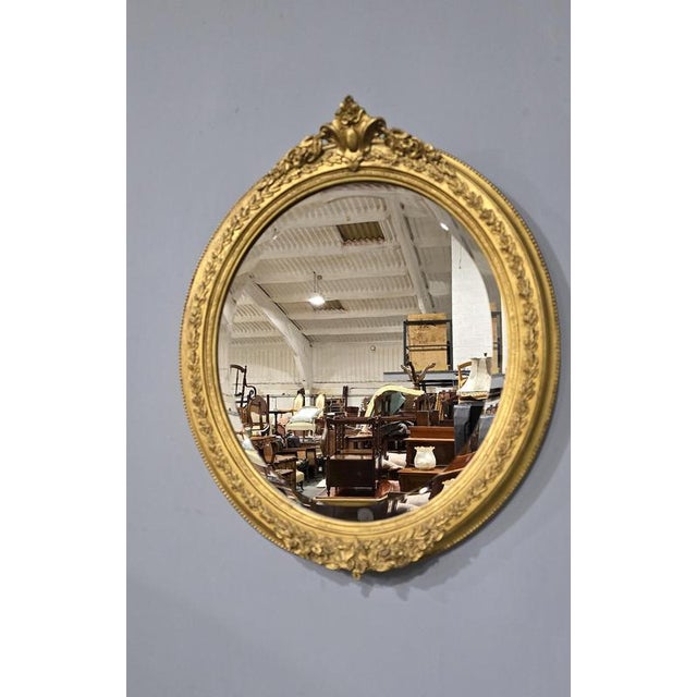 These are a superb pair of late 19th Century English antique oval gilt wall mirrors, small crest to the top bevelled...