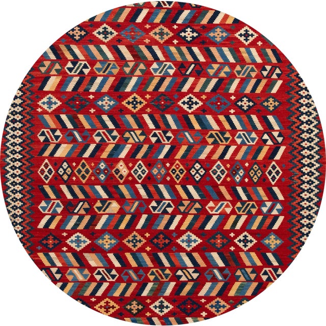 A beautiful hand-woven modern Kilim rug with a red field and multi-color accents in an all-over geometric design. This rug...