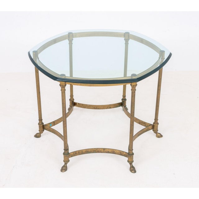 La Barge Style Glass Top and Brass Table, the hexagonal beveled glass top above six leg base with hoof feet, "Made in...