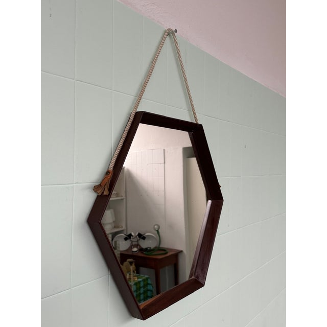 Hexagonal teak mirror made in Italy in the 1950s. The rope holding it is original. Dimensions: width 54 cm - length 47 cm...