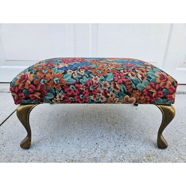 Plenty of color in the traditional upholstered floral print stool with brass-colored legs. The footstool is in very good...