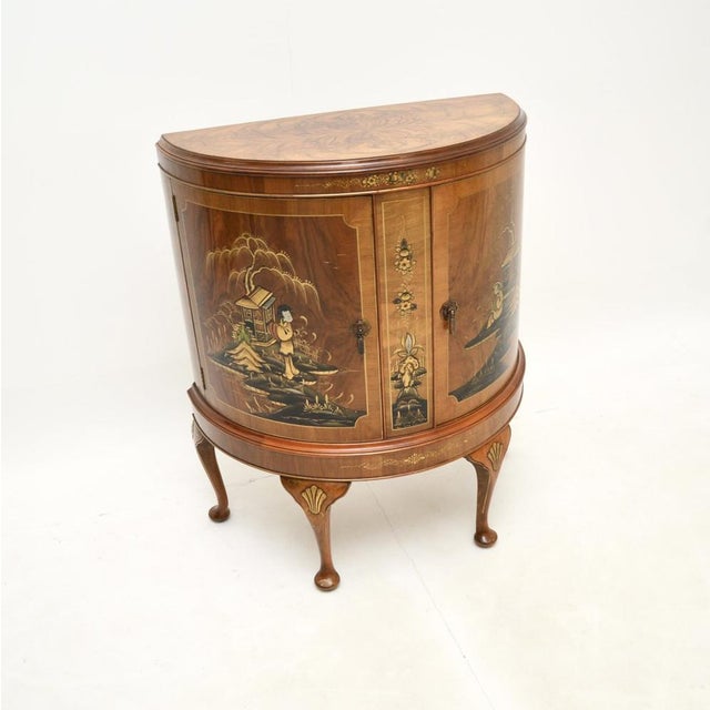 A stunning antique walnut and Chinoiserie cabinet, made in England and dating from around the 1920’s. It is of superb...