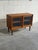 Pair of vintage Danish Mid Century Modern teak cabinets featuring sliding glass doors, adjustable shelving, and elegant...