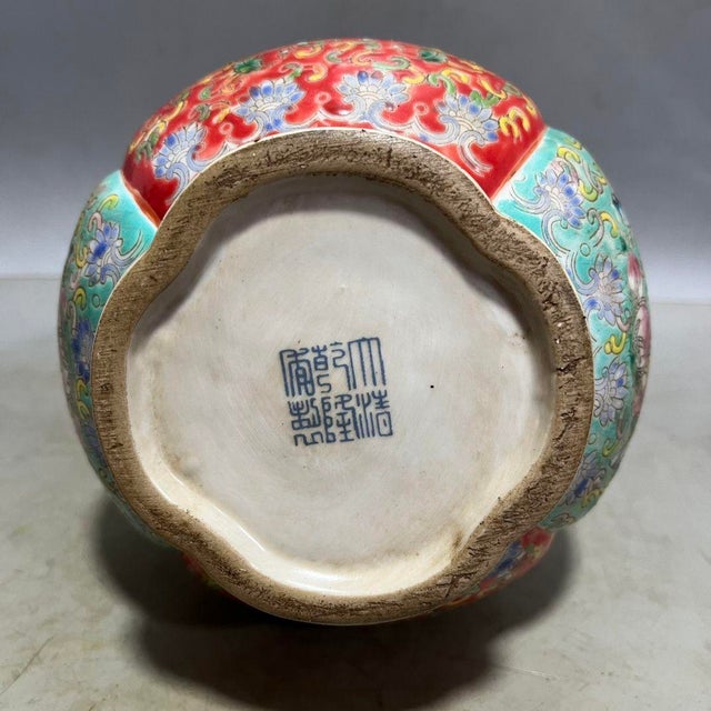 Ornate Chinese double gourd shaped porcelain vase with sculpted gilded ruyi form handles. The surface is richly decorated...