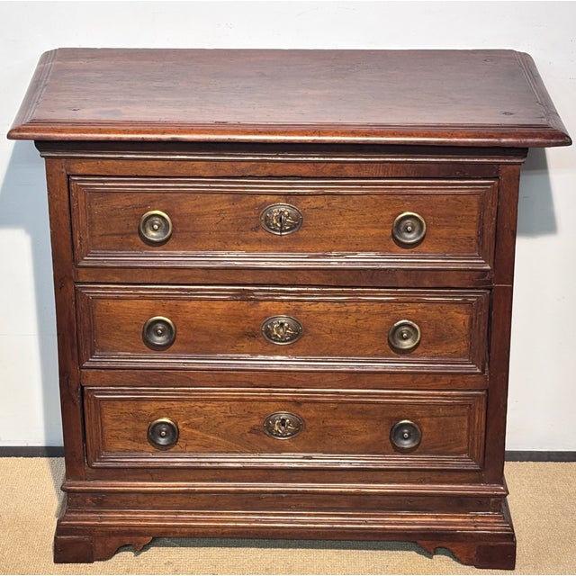 A 17th Century (possibly older at late 16th century) Italian walnut chest. This rare antique features three drawers, all...