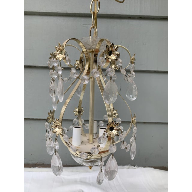 Vintage Metal Chandelier with crystal drops and flower motif. Formally hung in the Southern California estate used in the...