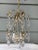 Vintage Metal Chandelier with crystal drops and flower motif. Formally hung in the Southern California estate used in the...