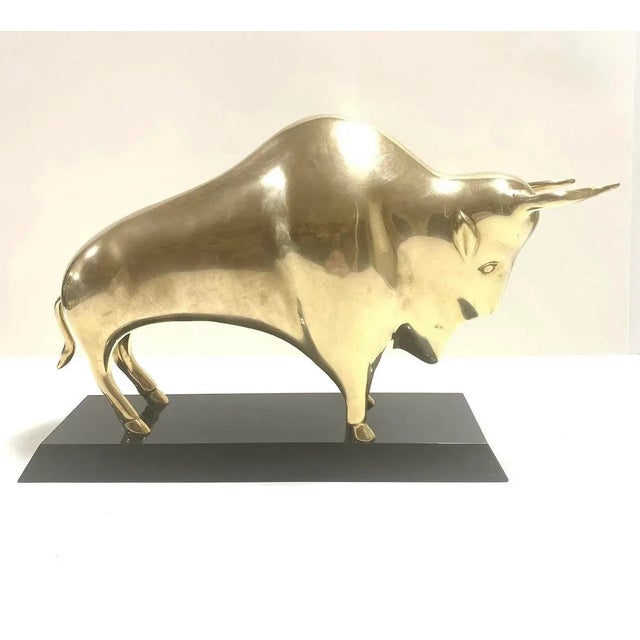 A striking mid century modern brass bull sculpture with bold, sculptural lines and rich patina. Substantial in weight and...