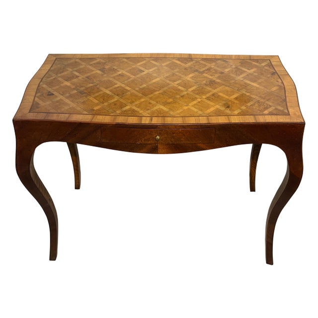 A vintage mid-century Italian writing table / desk, featuring a burled walnut and fruitwood parquetry inlay top, and...