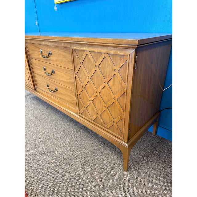 1960’s Mid Century Modern walnut nine drawer dresser/ credenza by United Furniture Company. The piece features 3 large...